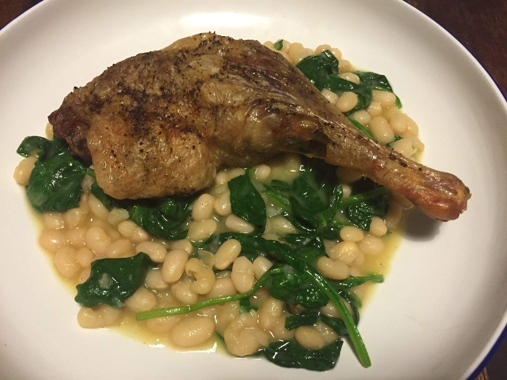Roast duck leg with white beans & spinach